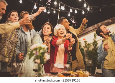 Storytelling footage of a multiethnic group of people dining on a rooftop. Family and friends make a reunion at home - Powered by Shutterstock