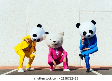 Storytelling image of a couple wearing giant panda head and colored suits. Man and woman making party in a parking lot.