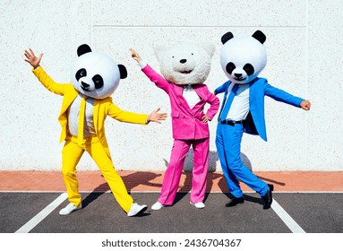 Storytelling image of a couple wearing giant panda head and colored suits. Man and woman making party in a parking lot.