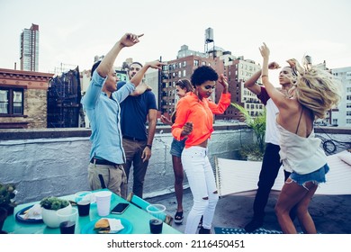 Storytelling Image Of A Group Of Teenagers Making Party On A Rooftop In New York City. Concept About Lifestyle And Youth