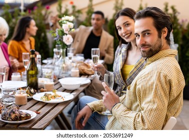 Storytelling image of a multiethnic group of people dining on a rooftop. Family and friends make a reunion at home.  - Powered by Shutterstock