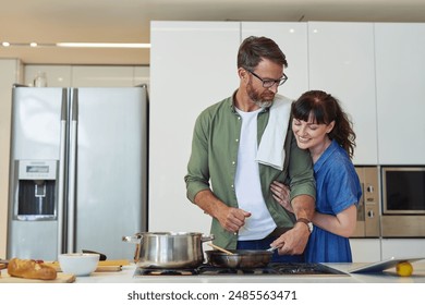 Stove, counter and couple with cooking in kitchen for support, healthy diet and bonding together. Man, pan and love of woman with hug in marriage for nutrition, meal prep and dinner date in house - Powered by Shutterstock