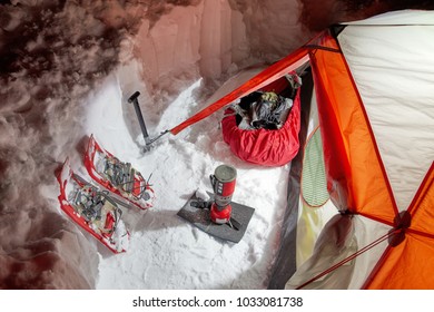 Stoves And Snowshoes Near The Tent In Winter Mountains Night.