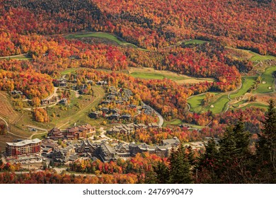 Stowe Mountain Resort in Stowe Vermont in fall Photo of the contrasting golf course green against the surrounding orange and yellow trees. Taken at the peak of the Fall foliage season in Stowe Vermont - Powered by Shutterstock