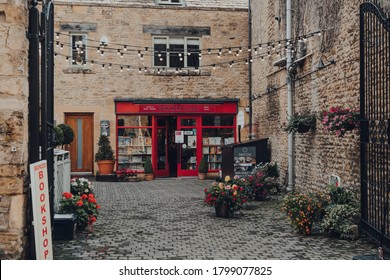Stow-on-the-Wold, UK - July 10, 2020: Borzoi bookshop front and walkway leading to it in Stow-on-the-Wold, a market town in Cotswolds, UK, built on Roman Fosse Way. Selective focus.