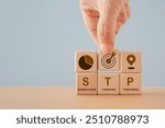 STP text ,abbreviation for Segmentation, Targeting, Positioning, and icon on wooden cube blocks. For marketing analysis, customer target, customer 