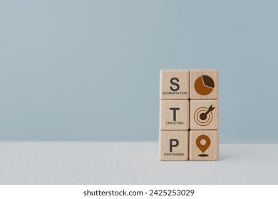 STP text ,abbreviation for Segmentation, Targeting, Positioning, and icon on wooden cube blocks. For marketing analysis, customer target, customer persona concept 