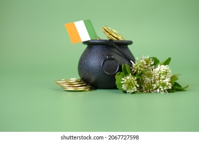 St.Patrick 's Day Background . Flag Of Ireland, Bowler Hat With Gold Coins, Bunch Of Clovers On A Green Background.