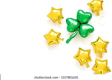 St.Patrick 's Day party decoration. Gold foil balloons of stars shapes and green balloons of clover leaf shaped. Holiday and celebration concept. Metallic air balloons. - Powered by Shutterstock