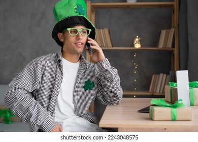 St.Patrick's Day, technology, people and holidays concept - serious man calling on smartphone at home - Powered by Shutterstock