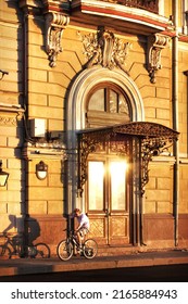 St.Petersburg, Russia - 05.31.2009. Cyclist Near The Door Of An Old House In The Golden Light Of The Sun, St. Petersburg
