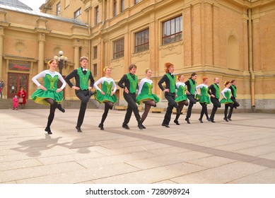 ST.PETERSBURG, RUSSIA - 9 APRIL 2017: Group of people in national costumes are dancing Irish dances on city street in the center of St. Petersburg.