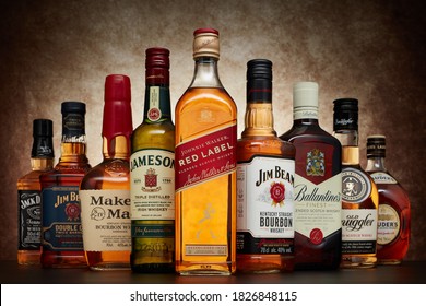 St.Petersburg, Russia - April  2020 - Bottle Of Johnnie Walker Red Label Blended Scotch Whisky On Background Of Other Popular Brands Of Whiskey (whisky) On Dark  Background