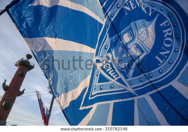 ST.PETERSBURG, RUSSIA, MAY 25, 2015: Fan holding a flag with symbols of the football club "Zenit" and the fans club "Nevsky Front" at the center of Saint Petersburg city, Russia 