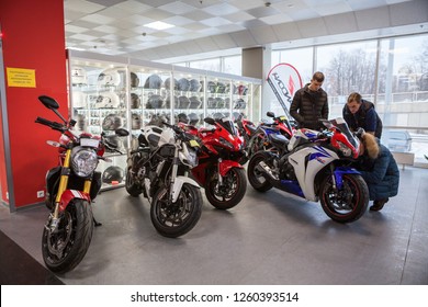 ST.PETERSBURG, RUSSIA-CIRCA DEC, 2018: Consultant helps customers choose motorcycle in the Megamoto store. Megamoto is shop with extensive choice of top quality used motorcycles and new outfit