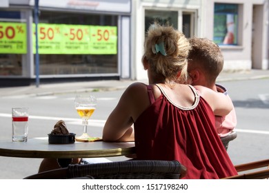 St.Pol-sur-Ternoise, Hauts-de-France/France-August 5 2019: A Young Couple Sitting Outside A Town Cafe On A Summer's Day