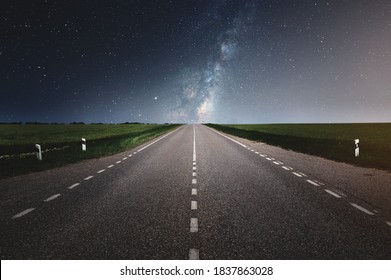 Straight Asphalt Country Road Under Clear Night Sky With Stars And Milky Way In Summer