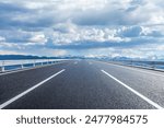 Straight asphalt highway road and snow mountains with sky clouds natural landscape. car background.
