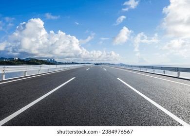 Straight asphalt highway and skyline under blue sky