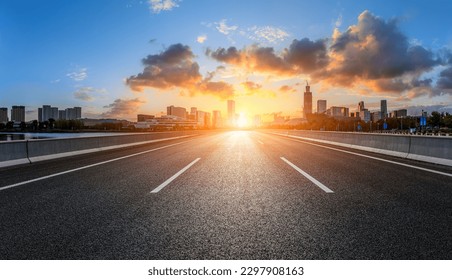 Straight asphalt road and city skyline with buildings scenery - Powered by Shutterstock