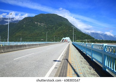 Straight Bridge Road With Mountain Background