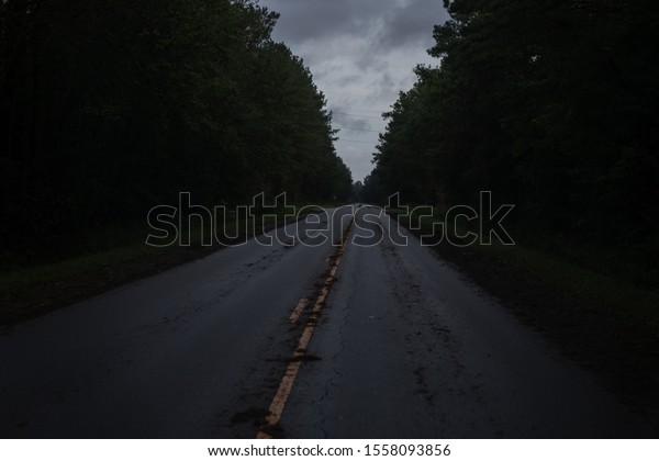 A straight country road littered with debris in North\
Carolina, USA