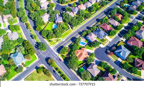 Straight down above four way stop Round Rock , Texas , USA Suburb growing outside of Austin high aerial drone view green end of summer colorful morning Millions of Homes vast Neighborhood Suburbia