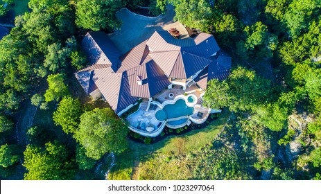 Straight Down Angle Luxury Mansion On Large Lot Of Land With Texas Hill Country Landscape And Surrounding Green Surroundings Of The Ranch Country Home With Infinity Pool And Wealthy Real Estate Living