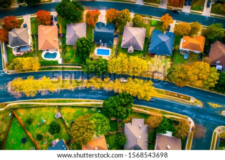 straight down drone views of suburbia housing development fall Autumn suburb suburbia round Rock Texas colorful landscape trees changing colors fall in central texas