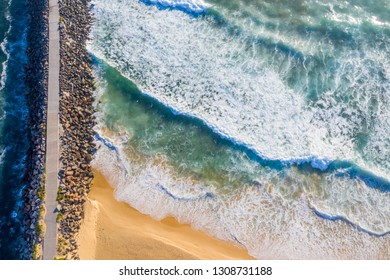 A Straight Down View Of The Breakwall At Nobbys Beach - Newcastle Australia With Rough Surf Pounding Onto The Shoreline. Nobbys BEach - Newcastle - NSW Australia