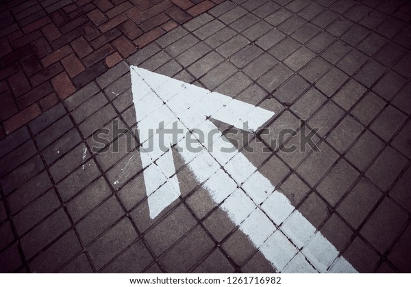 Straight forward sign on\
brick floor.