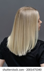 Straight Hair After Bleaching Process. Look From Behind. Hair Care