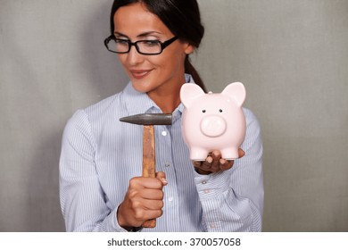 Straight Hair Female Holding Hammer And Breaking Piggy Bank In Formal Wear And Glasses On Grey Texture Background