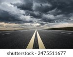 Straight highway road with black rain clouds natural landscape before the rainstorm