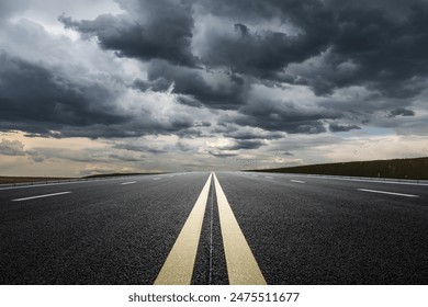 Straight highway road with black rain clouds natural landscape before the rainstorm - Powered by Shutterstock