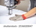 Straight knife cutter and stainless steel gloves in a clothing factory