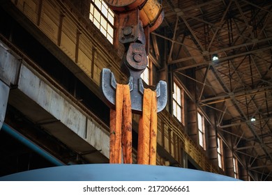 Straight Metal Hook Assembly Of Moving Crane With Hanging Orange Strops In Spacious Workshop Of Production Plant Close View