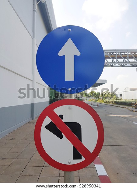straight and not turn\
left sign on walkway