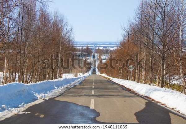 Straight path with snowy scenery in Shari,\
Shiretoko, Hokkaido,\
Japan