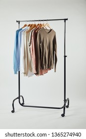 Straight Rack, Wooden Hangers And Male Clothes Isolated On Grey