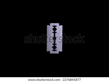 straight razor blade, steel blade on a black background close-up. place for text