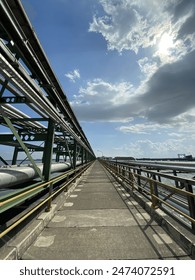 A straight road between constructions.