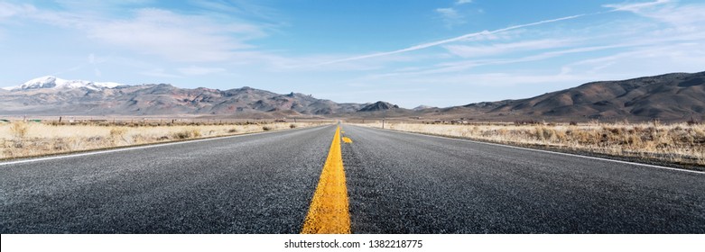 Straight Road In Desert With Mountains,  Low Angle Photograph