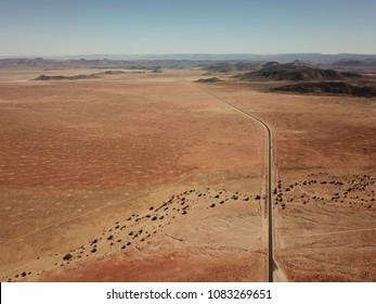 Straight road running through the hot Namibian desert.  - Powered by Shutterstock