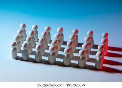 Straight rows of little men. People without individual traits. Suppression of individuality. Political parties or the army. Multitude of faceless people - Shutterstock ID 1917820379