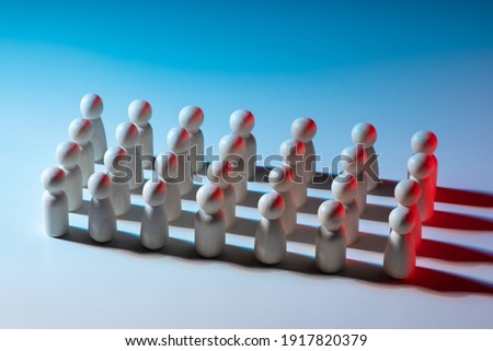 Straight rows of little men. People without individual traits. Suppression of individuality. Political parties or the army. Multitude of faceless people