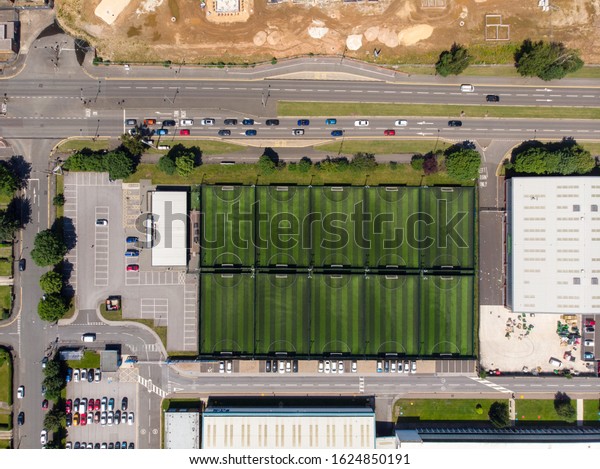 Straight top down aerial photo of the Goals Soccer\
Centre football pitches located in the town of Doncaster, South\
Yorkshire in the UK showing the soccer football pitches along side\
a main road.