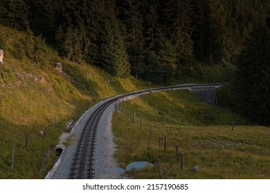 Straight track of narrow cog railway on the shafberg mountain in upper austria. Romantic view of old train track high up on the mountain.