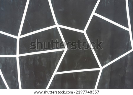 straight white lines on a black wall. geometrically straight lines on the facade