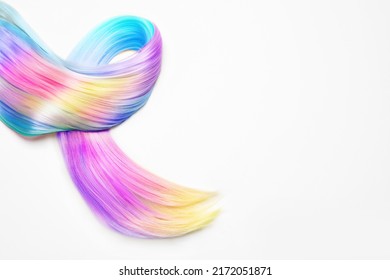 Strand beautiful multicolored hair white background  top view